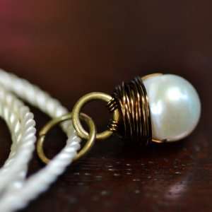 Sea Stone Pendant   white pearl wire wrapped in bronze with ivory cord