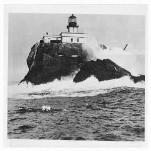    Lighthouse atop rock formation,1940,Waves crashing