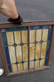 Old stained glass church window in wood frame +  