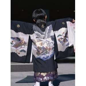  Back View of a Small Boyin Traditional Clothing at the 